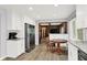 Updated kitchen with stainless refrigerator, white cabinets, wood flooring, and granite countertops at 781 Dayton Dr, Carmel, IN 46033