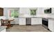 Bright updated kitchen with white cabinets, granite countertops, stainless appliances, and wood floors at 781 Dayton Dr, Carmel, IN 46033