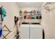 This laundry room features a front load washer and dryer set with convenient shelf space and storage at 781 Dayton Dr, Carmel, IN 46033