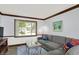 Cozy living room with a large sectional sofa, decorative pillows, stylish coffee table, and a bright window at 781 Dayton Dr, Carmel, IN 46033