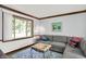 Bright living room featuring a gray sectional sofa, stylish coffee table, and large window with natural light at 781 Dayton Dr, Carmel, IN 46033
