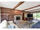 Inviting living room with a stone fireplace, built-in shelving, and sliding doors to the outdoor space at 781 Dayton Dr, Carmel, IN 46033