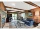 Cozy living room with a stone fireplace, classic decor, and a sliding glass door to the backyard at 781 Dayton Dr, Carmel, IN 46033