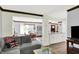 Open-concept living room flows into dining area with hardwood floors and white kitchen cabinets at 781 Dayton Dr, Carmel, IN 46033
