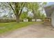 Spacious backyard with mature trees, concrete patio, and wooden fence provides privacy and outdoor enjoyment at 7835 E 50Th St, Indianapolis, IN 46226