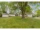 Large backyard with mature trees and shed offers ample space for outdoor activities and storage at 7835 E 50Th St, Indianapolis, IN 46226