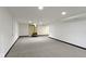 Basement space featuring modern carpeting, bright lighting, and a unique fireplace at 7835 E 50Th St, Indianapolis, IN 46226
