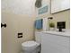 Stylish bathroom with a modern toilet and vanity with unique floral wallpaper at 7835 E 50Th St, Indianapolis, IN 46226