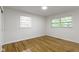 Bright bedroom with hardwood floors, two windows, and ample natural light at 7835 E 50Th St, Indianapolis, IN 46226