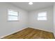 Bright bedroom featuring hardwood floors, fresh paint, and natural light from two windows at 7835 E 50Th St, Indianapolis, IN 46226