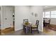 A charming dining area with seating for two, decorative wall art, and an open view to another space at 7835 E 50Th St, Indianapolis, IN 46226