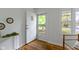 Bright entryway with hardwood floors, offering a glimpse of the outdoors through the glass paneled front door at 7835 E 50Th St, Indianapolis, IN 46226