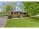 Charming single-story home with a well-maintained lawn and a red trim, offering great curb appeal at 7835 E 50Th St, Indianapolis, IN 46226