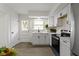 Bright kitchen featuring stainless steel appliances, white cabinets, and a door leading to the outside at 7835 E 50Th St, Indianapolis, IN 46226