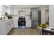 Modern kitchen with white cabinets, stainless steel refrigerator, and sleek appliances at 7835 E 50Th St, Indianapolis, IN 46226