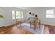 Bright living room with hardwood floors, neutral decor, and large windows offering ample natural light at 7835 E 50Th St, Indianapolis, IN 46226