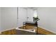 Minimalist office features hardwood floors, a glass top desk, and cozy chair at 7835 E 50Th St, Indianapolis, IN 46226