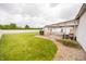 Enjoy the lush backyard with an in-ground pool, white house, and covered seating area at 7895 E 175 N, Franklin, IN 46131
