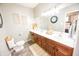 Bathroom featuring double sink vanity with dark wood cabinets and a framed mirror at 7895 E 175 N, Franklin, IN 46131