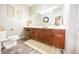 Bathroom featuring a double sink vanity with dark wood cabinets and a framed mirror at 7895 E 175 N, Franklin, IN 46131