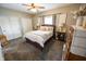 Cozy bedroom with a ceiling fan, natural light, and neutral decor, creating a comfortable and inviting retreat at 7895 E 175 N, Franklin, IN 46131
