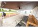 Relax on the covered patio with seating and a fan; the in-ground pool is a few steps away at 7895 E 175 N, Franklin, IN 46131