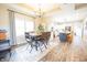Bright dining area with wood table, stylish rug, chandelier, and an adjacent modern kitchen, creating an inviting space at 7895 E 175 N, Franklin, IN 46131