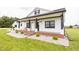 Charming house exterior featuring a brick porch with black accents and landscaped yard at 7895 E 175 N, Franklin, IN 46131