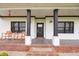 Warm and welcoming front porch with black accents, including a decorative wreath on the front door at 7895 E 175 N, Franklin, IN 46131