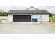 Detached garage with black garage door and white siding next to in ground pool at 7895 E 175 N, Franklin, IN 46131