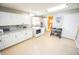 Spacious laundry room with front loading washer and dryer, white cabinets, and a view into the bathroom at 7895 E 175 N, Franklin, IN 46131