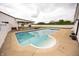 Beautiful in-ground pool with white house and covered patio seating in the background at 7895 E 175 N, Franklin, IN 46131