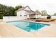 Beautiful in-ground pool with white house and outdoor structure in the background at 7895 E 175 N, Franklin, IN 46131