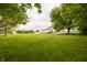 Expansive green lawn with trees and featuring a white barn and main house at 7895 E 175 N, Franklin, IN 46131