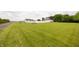 Expansive green lawn surrounded by trees and featuring a white barn and main house at 7895 E 175 N, Franklin, IN 46131