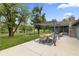 Back patio with outdoor dining area and pergola with lake views at 8029 Castle Lake Rd, Indianapolis, IN 46256