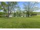 Tranquil backyard with expansive green space and a picturesque lake at 8029 Castle Lake Rd, Indianapolis, IN 46256