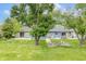 Large, grassy backyard with an outdoor fire pit and multiple seating areas at 8029 Castle Lake Rd, Indianapolis, IN 46256