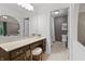 A bathroom vanity features a stool with a view into the ensuite at 8029 Castle Lake Rd, Indianapolis, IN 46256
