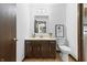 A bathroom with a dark wood vanity, toilet, mirror, and decor at 8029 Castle Lake Rd, Indianapolis, IN 46256