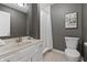 Neutral bathroom featuring a shower with white subway tile and a single sink vanity at 8029 Castle Lake Rd, Indianapolis, IN 46256