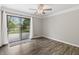 A bedroom with a patio door to a balcony with a view of a lake at 8029 Castle Lake Rd, Indianapolis, IN 46256