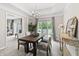 Bright dining room with modern chandelier, elegant table setting, and large window at 8029 Castle Lake Rd, Indianapolis, IN 46256