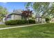 Beautiful stone home with a turret entrance, American flag, and lush green lawn at 8029 Castle Lake Rd, Indianapolis, IN 46256
