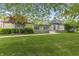 Charming stone home with turret entrance, manicured lawn, and inviting curb appeal at 8029 Castle Lake Rd, Indianapolis, IN 46256