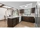 A kitchen boasting wood floors, wooden ceiling beams, white countertops, and dark wood cabinets at 8029 Castle Lake Rd, Indianapolis, IN 46256