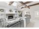 Open living room with vaulted ceiling, wood beams, stone fireplace, and large sectional at 8029 Castle Lake Rd, Indianapolis, IN 46256