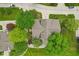 Aerial view of a home with a grey roof, surrounded by lush green trees and well-maintained landscaping at 9054 Cinnebar Dr, Indianapolis, IN 46268