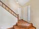 Welcoming foyer with hardwood floors, staircase, and a sidelight window by the front door at 9054 Cinnebar Dr, Indianapolis, IN 46268