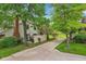 Exterior view of a home showcasing a long driveway, mature trees, and a well-manicured lawn at 9054 Cinnebar Dr, Indianapolis, IN 46268